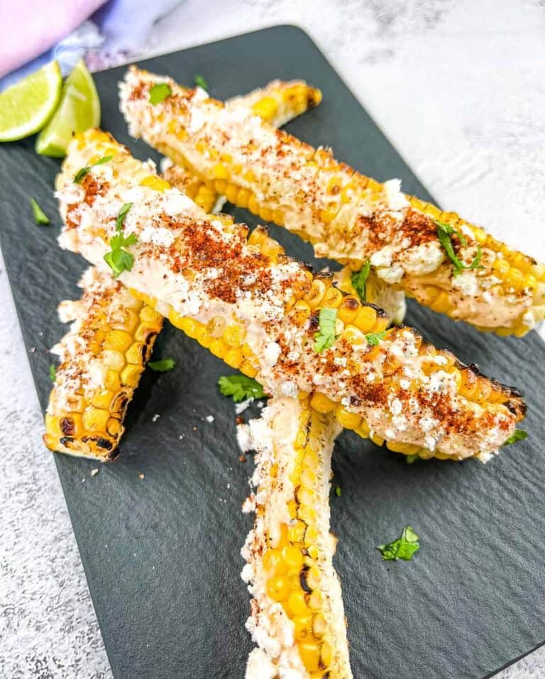 Grilled Elote Corn Ribs on a black platter.