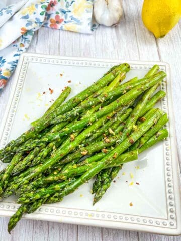 Grilled Asparagus with Garlic on a white platter.