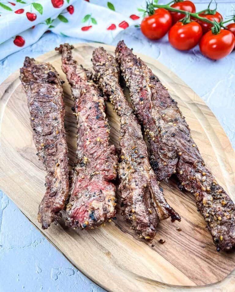 Grilled beef finger meat on a cutting board.