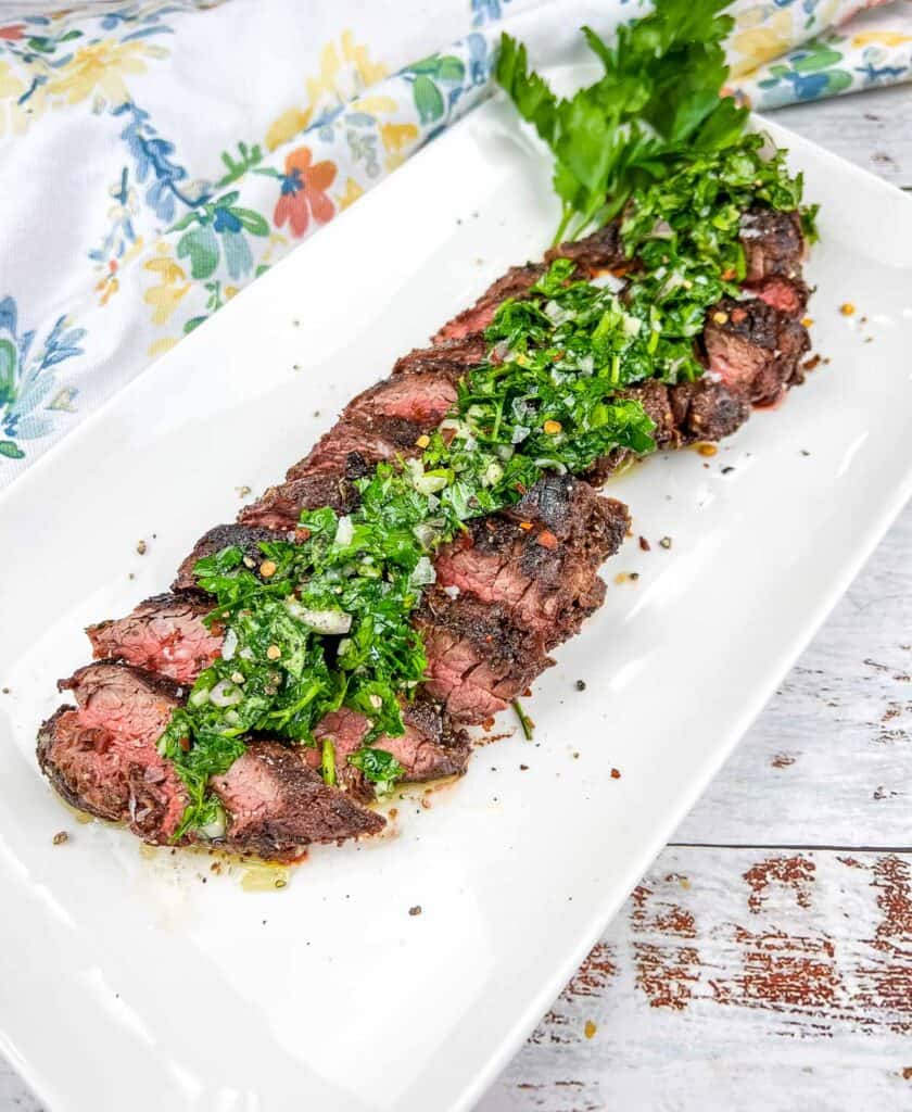 Grilled Hanger Steak with Chimichurri on a platter.