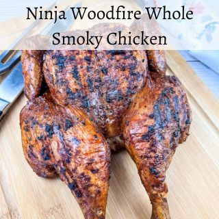 Ninja Woodfire Whole Smoky Chicken on a cutting board.
