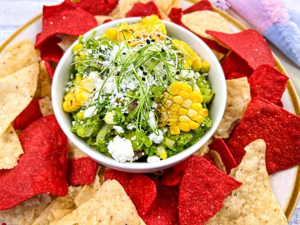 Grilled Corn Guacamole surrounded by tortilla chips.