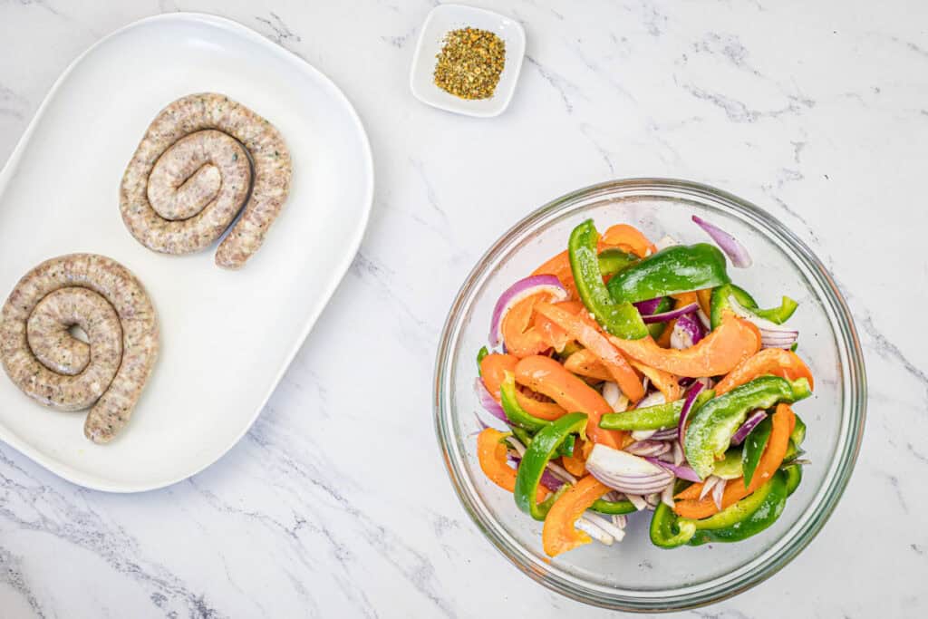 Sausage coil, Italian seasoning, and olive oil-coated veggies.
