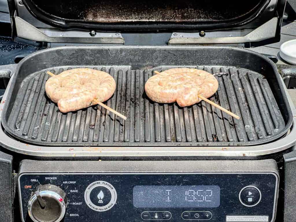 Add the skewered sausage coils to the grill and cook for 5-6 minutes.