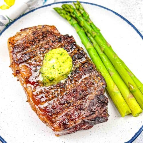 Vertical shot of Smoked Reverse-Seared Steaks with Smoked Garlic Butter.