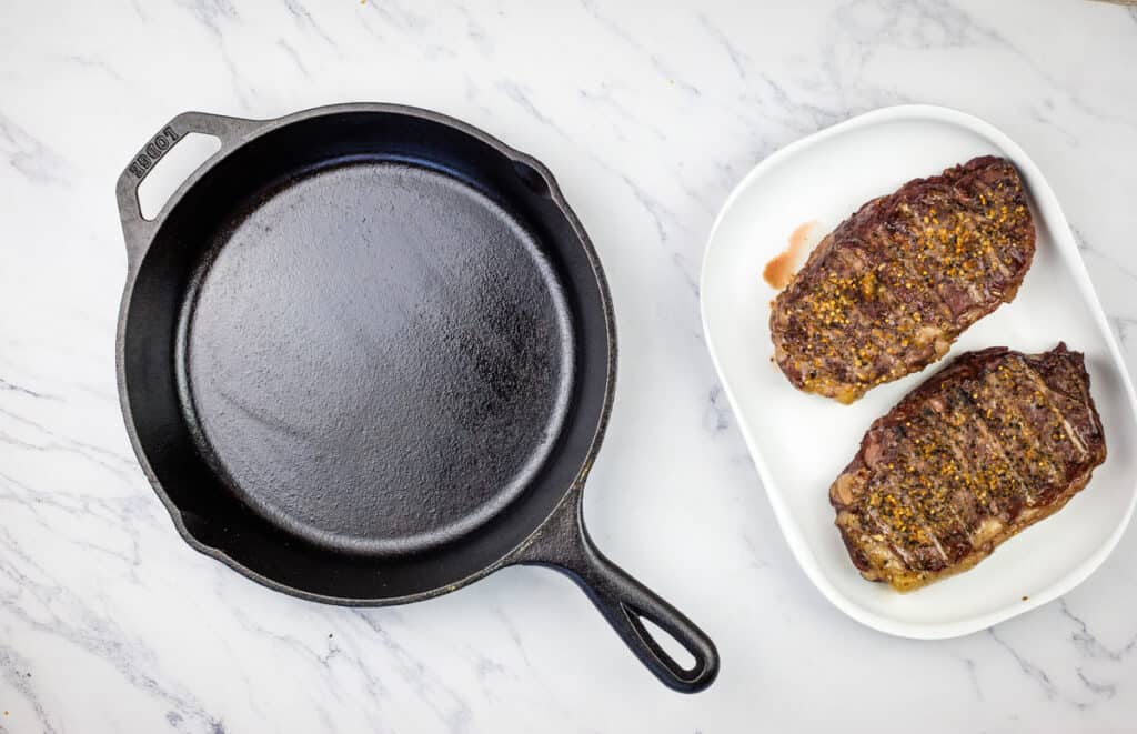 Place the steaks on the smoker and cook.