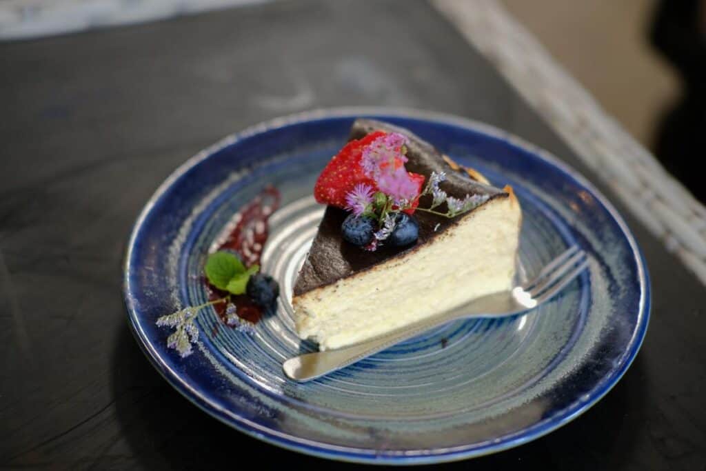 Homemade keto vegan flourless cheesecake decorated with flowers.