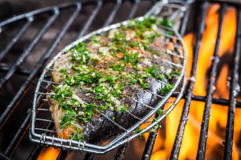 Grilled fish with spices on fire.