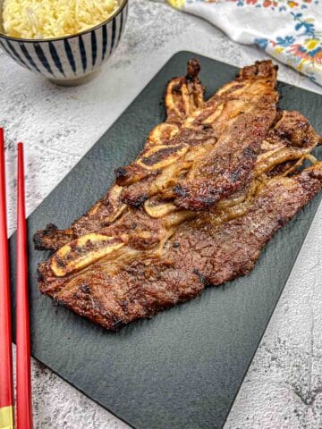 Korean Galbi Ribs on a black slate plate.