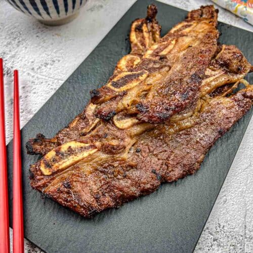 Korean Galbi Ribs on a black slate plate.