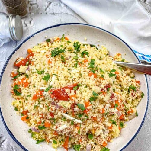 A serving bowl of Mediterranean Couscous with Tomatoes.