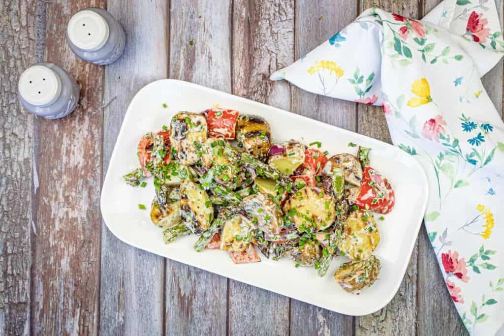 Top-down shot of Grilled Asparagus and Potato Salad on a white plate.