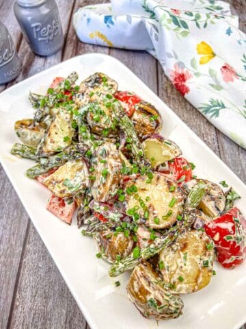 Grilled Asparagus and Potato Salad on a white rectangular plate.