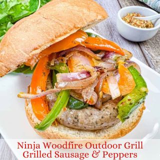 Ninja Woodfire Outdoor Grill Grilled Sausage & Peppers on a white plate.
