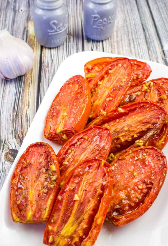 Close up shot of Smoked Tomatoes on a white plate.