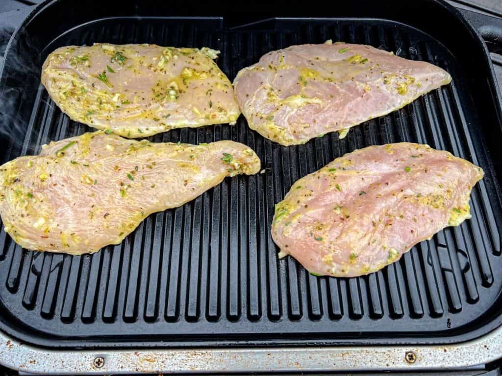 Place the chicken on the grill and cook for 3-4 minutes on each side.