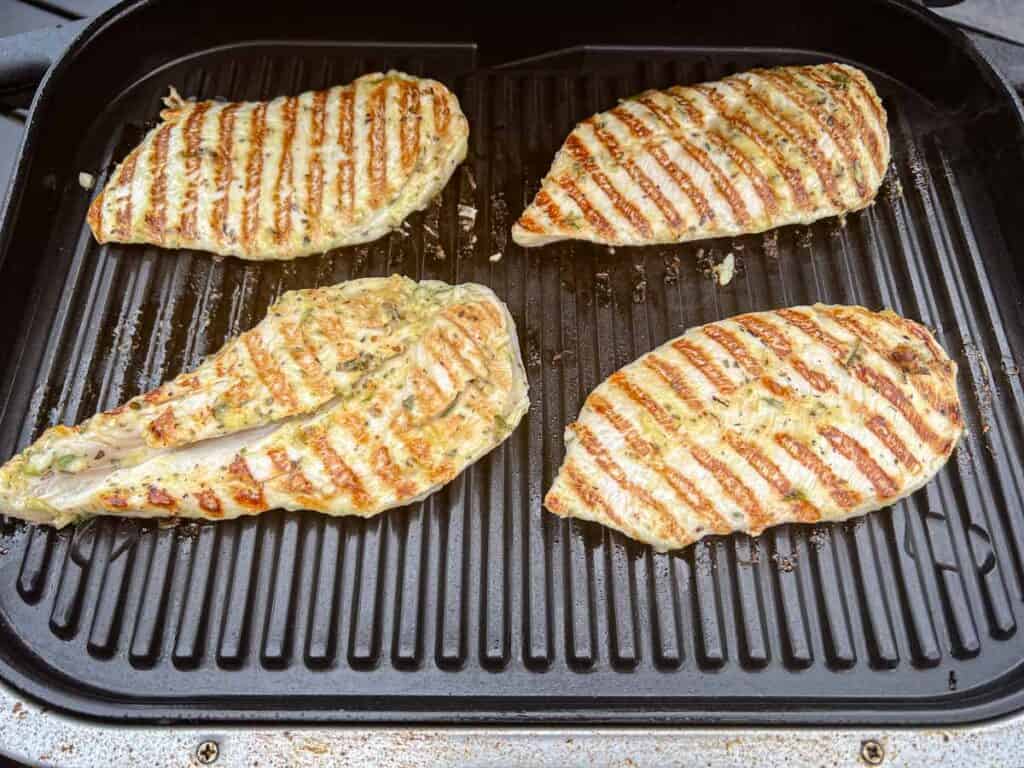 Remove the chicken from the grill and let it rest for a few minutes before slicing.
