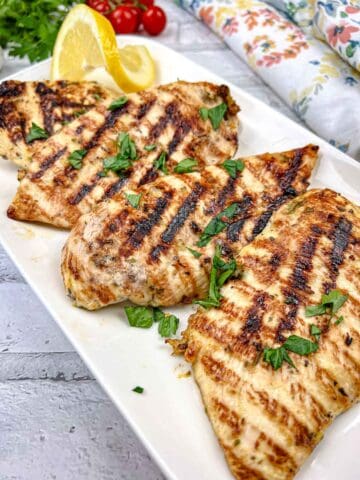 Ninja Woodfire Grill Lemon-Herb Chicken served on a white rectangular plate.