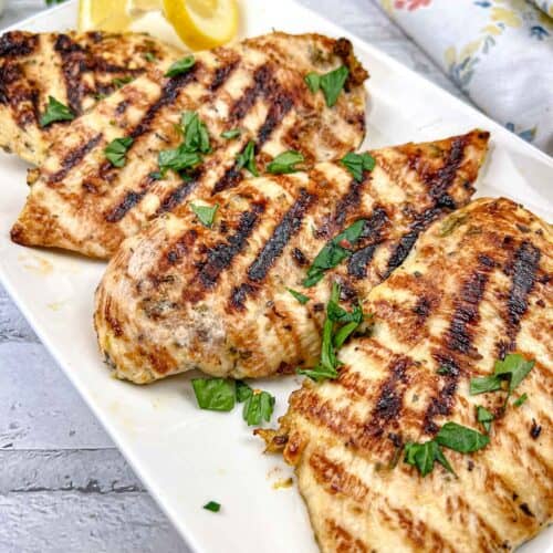 Ninja Woodfire Grill Lemon-Herb Chicken served on a white rectangular plate.