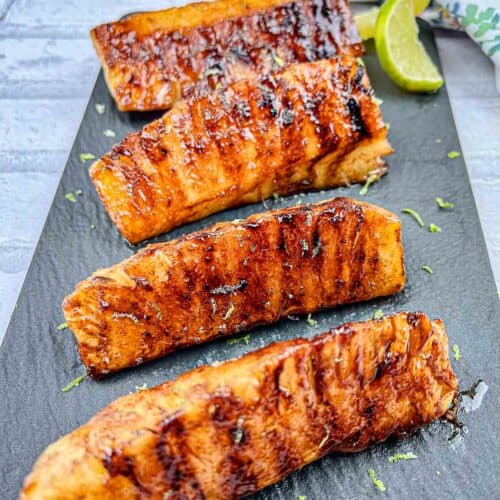 Grilled Pineapple With Buttery Lime Glaze served on a black slate plate.