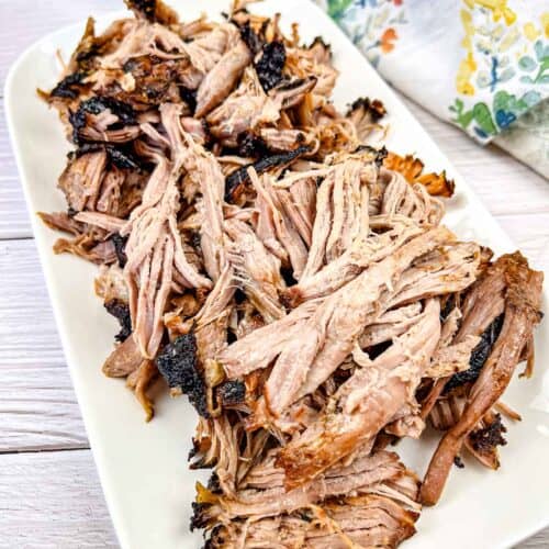 Ninja Woodfire Outdoor Grill Smoked Pulled Pork on a white plate.