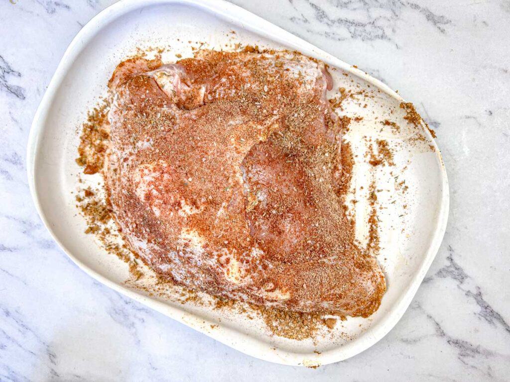 Rub the spice mixture all over the turkey breast, making sure to coat it evenly.