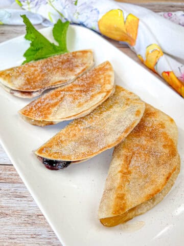Four pieces of Fruit Quesadillas on a plate.