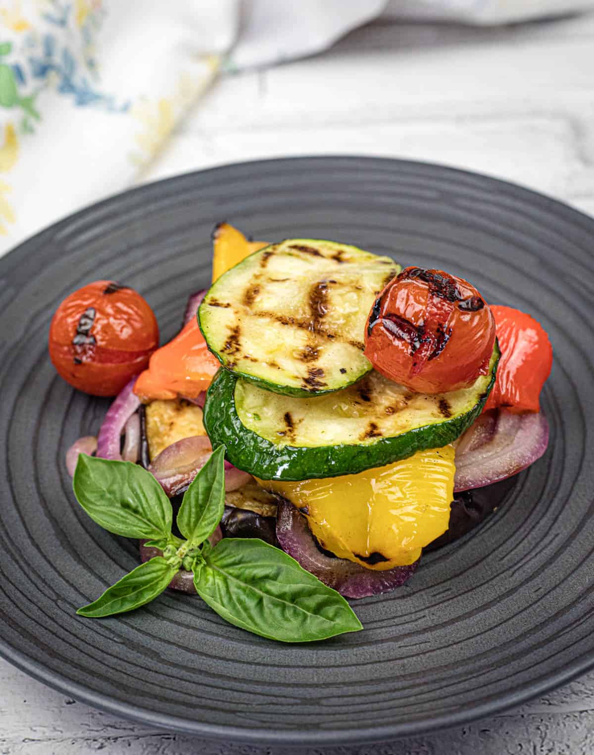 Grilled Ratatouille on a black plate.