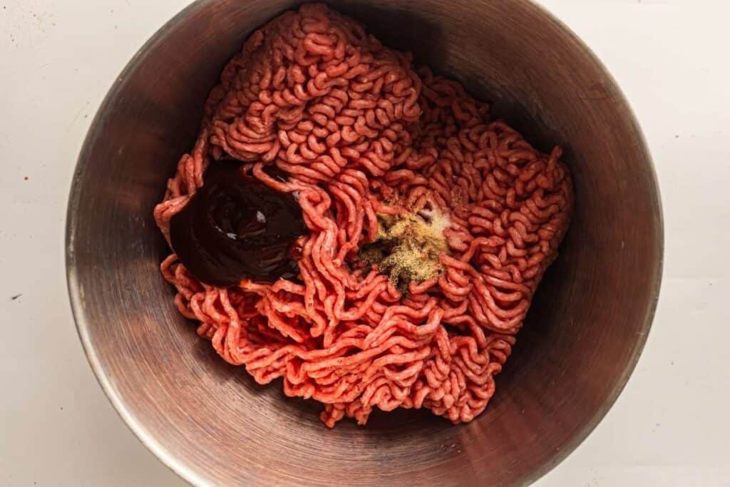 Combine the ground beef, BBQ sauce, salt, black pepper, garlic powder, and onion powder..