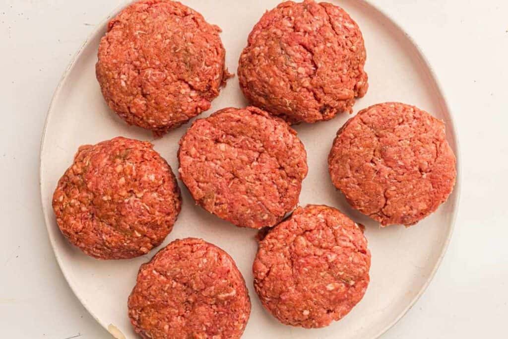 Press a small indentation in the center of each patty with your thumb.
