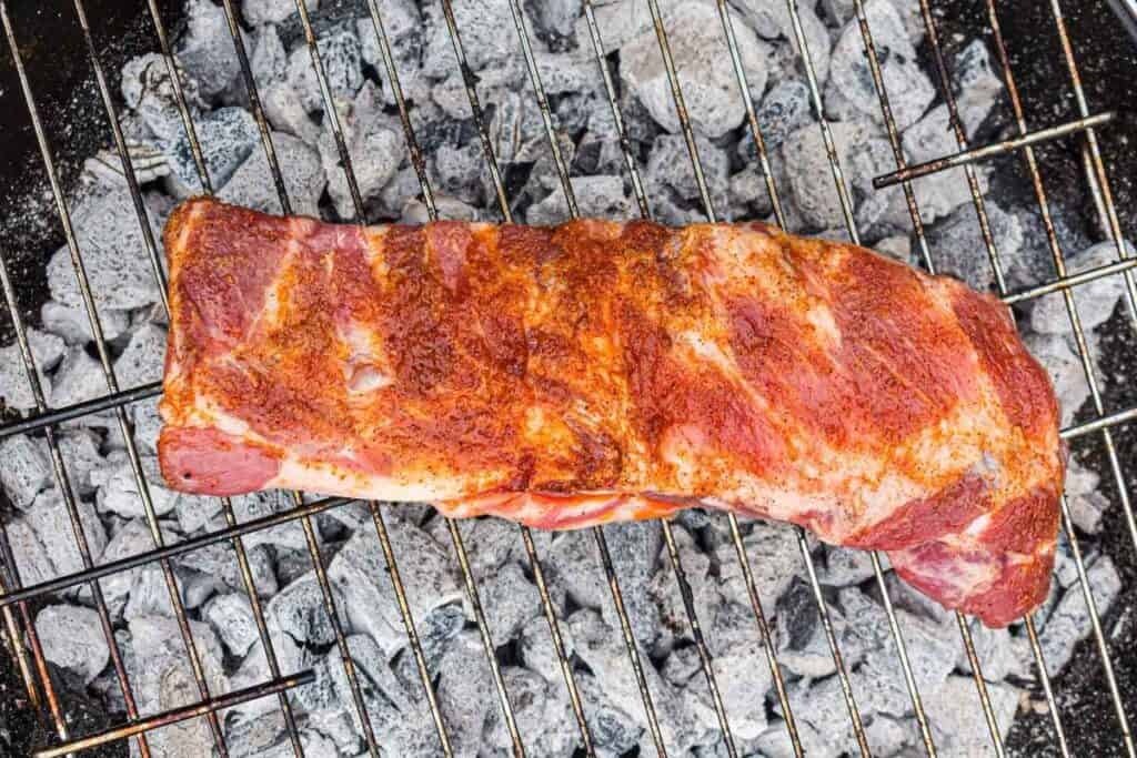 Place the ribs on the cool side of the grill, bone-side down.