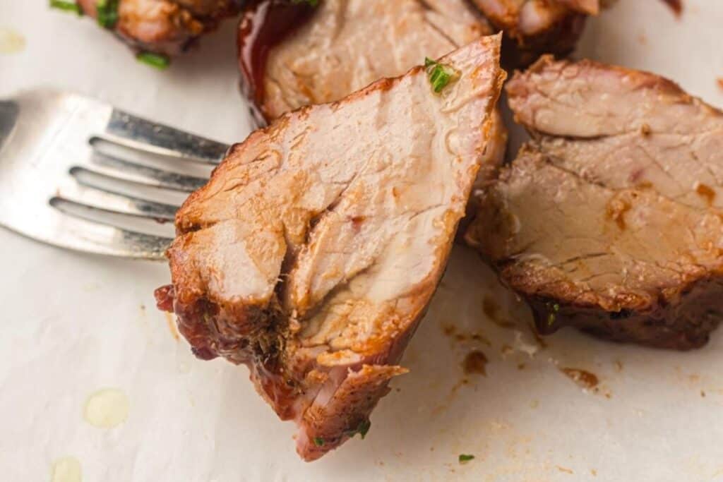 A close-up shot of Grilled Pork Tenderloin on a plate.